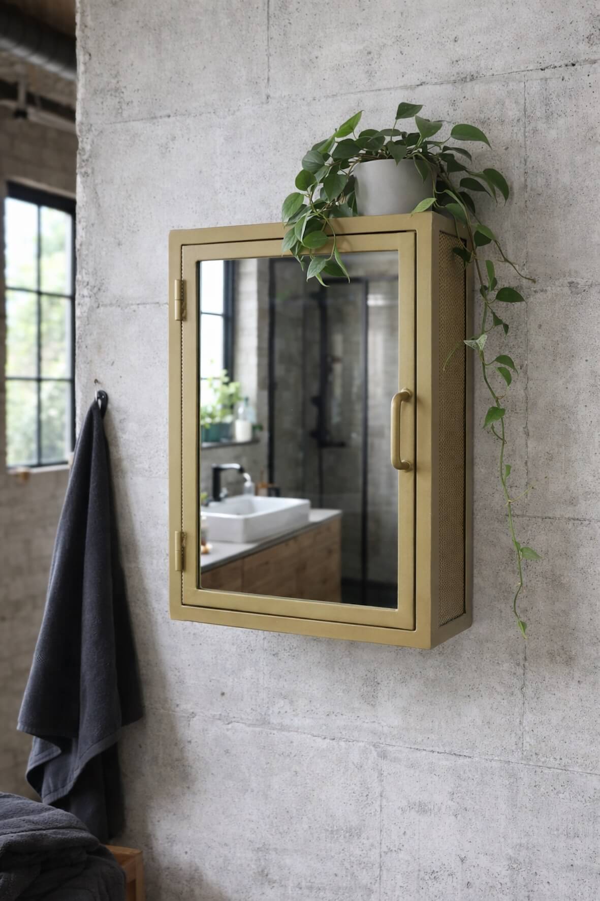 Industrial Mirrored Bathroom Wall Cabinet Antique Brass on concrete wall