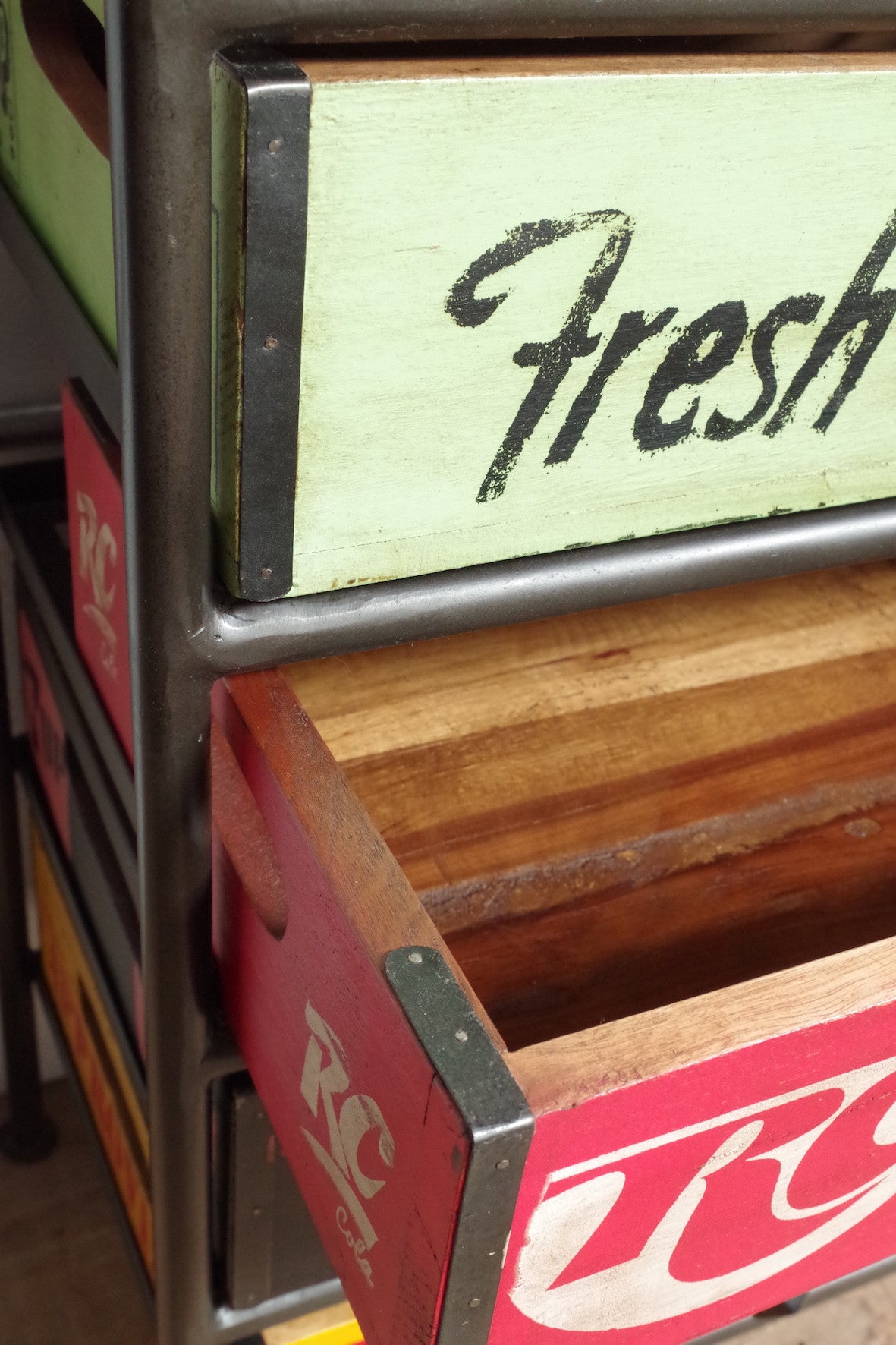 Black metal frame unit with 5 vintage style soda crate drawers.