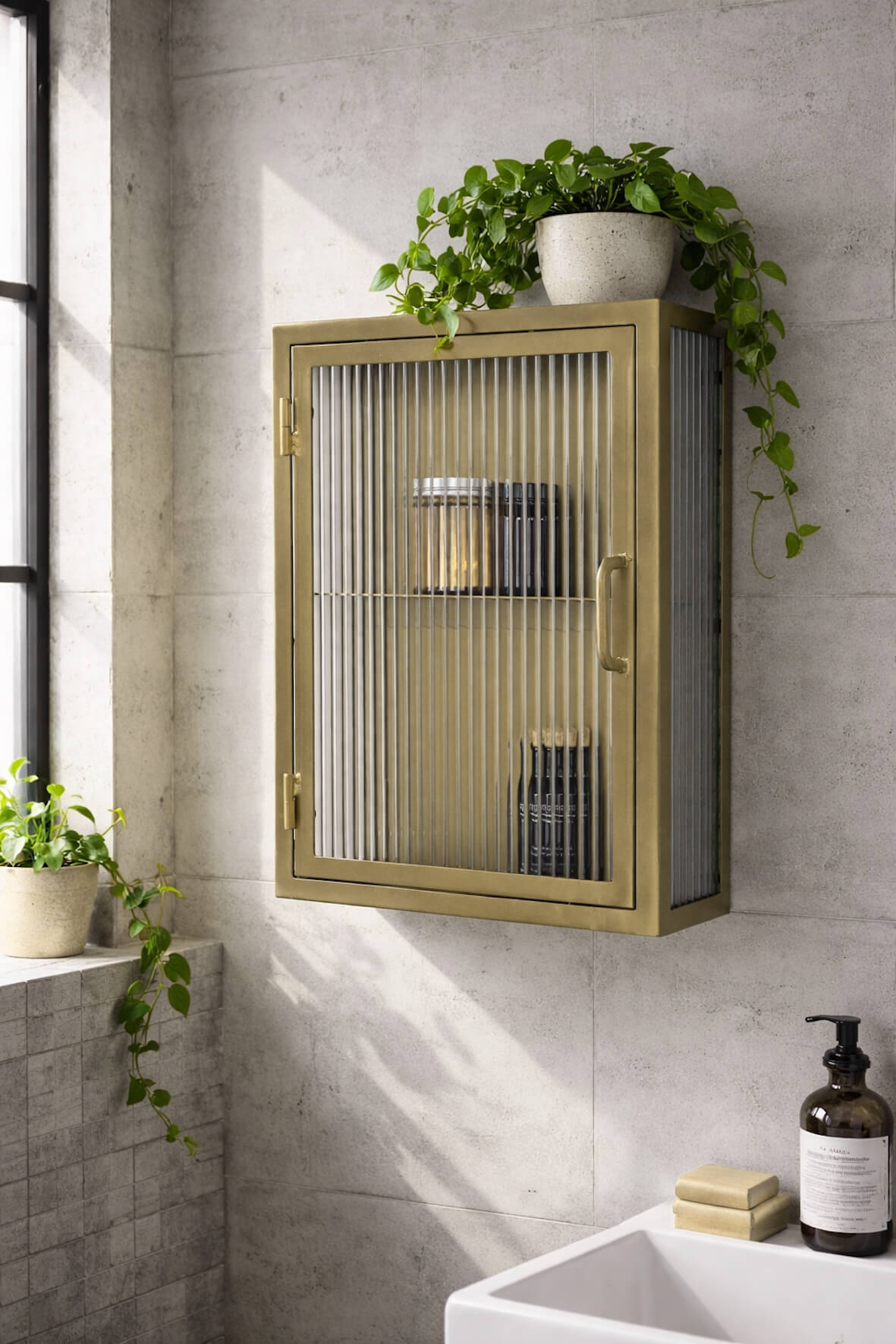 Industrial Fluted Glass Bathroom Cabinet Antique Brass on a concrete wall