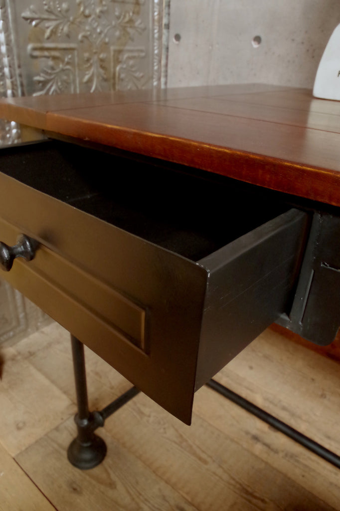 Industrial steampunk Desk with black metal legs and drawers and a wooden top.  